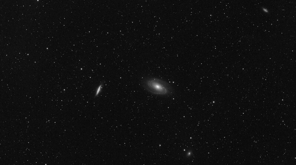 M81 (center) or Bode's Galaxy is a spiral galaxy, pictured with Messier 82 (left), also known as the Cigar Galaxy, a prototype nearby starburst galaxy.  Both are about 12 million light-years away in the constellation Ursa Major.  
